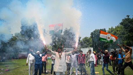 Congress supporters burst crackers to celebrate the win of Congress Party in Karnataka Assembly Elections at AICC on May 13, 2023 in New Delhi, India.